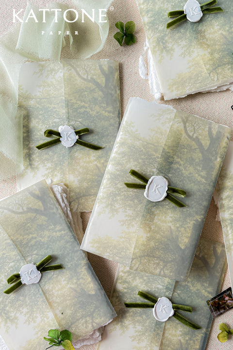 Vellum jackets and white wax seals with velvet ribbons