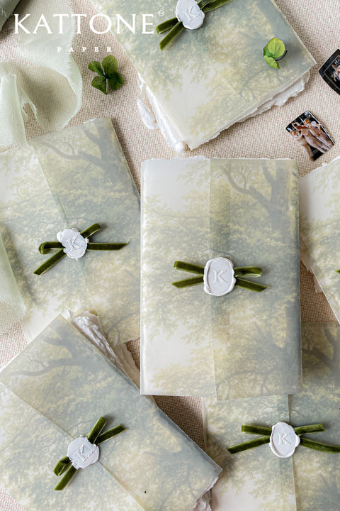 Vellum jackets and white wax seals with velvet ribbons