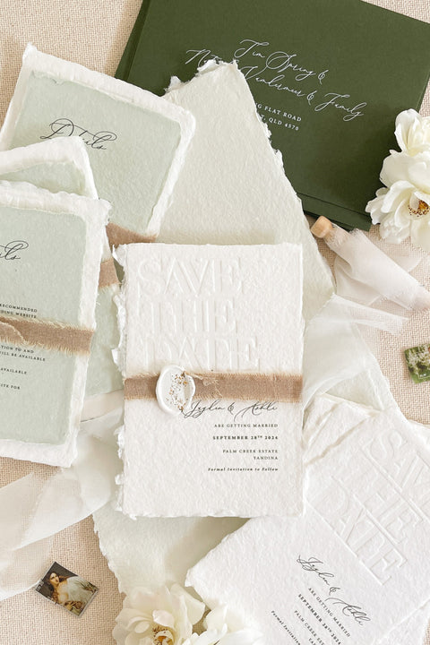 Introduce your wedding with understated elegance through our embossed handmade paper Save the Date cards - a luxurious design that combines fine-art minimalism with tactile sophistication. Each card is pressed onto 100% cotton handmade paper with natural deckled edges, featuring a blind embossed “Save the Date” design that creates a refined, sculptural texture you can see and feel. Wrapped in natural jute twine and finished with a handcrafted wax seal.