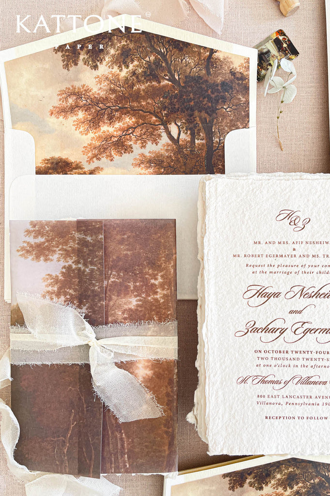 Premium handmade paper wedding invitation suite with custom scenic artwork, vellum wraps, deckled edge cotton paper, and elegant calligraphy for romantic luxury weddings.