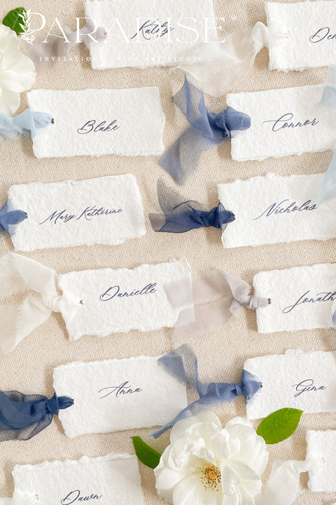 Add soft, romantic detailing to your tablescape with our silk ribbon handmade paper place cards, crafted from premium cotton rag paper and finished with naturally torn deckled edges. Each name tag is threaded with airy, hand-dyed silk ribbon and printed in elegant calligraphy, creating a luxurious fine-art look for weddings, rehearsal dinners, and intimate celebrations. These artisan-crafted cards bring movement, texture, and timeless beauty to your event design.
