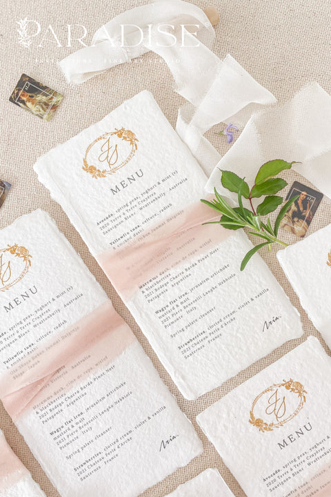 Add an air of refined romance to your wedding reception with our handmade paper wedding menus, beautifully adorned with a custom monogram and silk ribbon. Each menu is printed on luxurious 100% cotton rag paper with soft, torn deckled edges - a hallmark of artisanal craftsmanship. Designed for couples who value timeless design and tactile beauty, these menus feature elegant gold monograms paired with delicate blush silk ribbon wraps, creating a cohesive, fine art-inspired look.