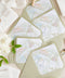 Elegant matcha green envelopes arranged with floral details for refined wedding invitations.