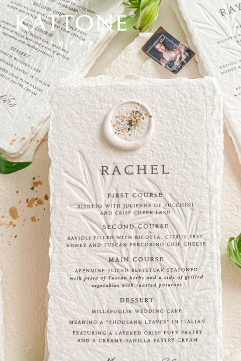 These embossed handmade paper wedding menus embody the essence of refined elegance and timeless artistry. Each piece is crafted from 100% cotton rag paper, known for its organic texture and signature deckled edges that add an artisanal, heirloom feel. The design features delicate blind embossing of botanical motifs, adding soft dimension and sophistication, while luxurious typography in classic ink beautifully contrasts the natural paper’s tactile surface.