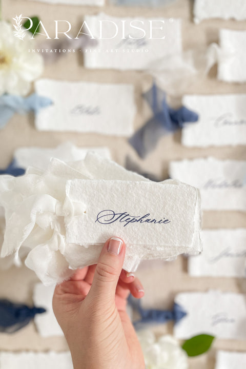 Add soft, romantic detailing to your tablescape with our silk ribbon handmade paper place cards, crafted from premium cotton rag paper and finished with naturally torn deckled edges. Each name tag is threaded with airy, hand-dyed silk ribbon and printed in elegant calligraphy, creating a luxurious fine-art look for weddings, rehearsal dinners, and intimate celebrations. These artisan-crafted cards bring movement, texture, and timeless beauty to your event design.