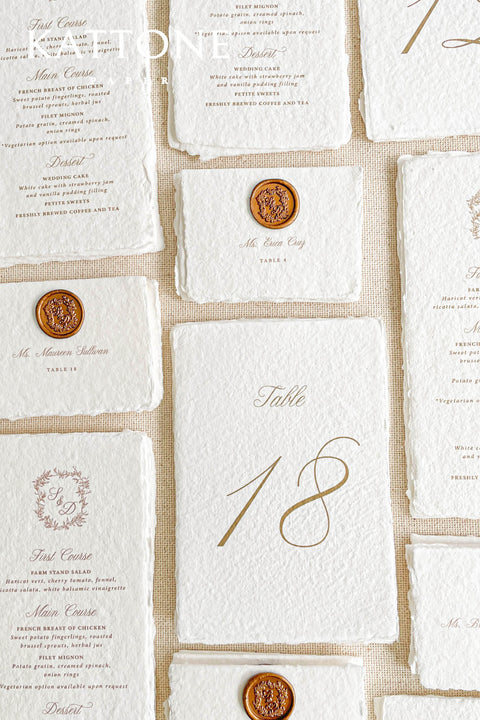 Create an elegant, heirloom-inspired tablescape with our handmade paper place cards, each finished with a luxurious bronze wax seal and finely printed guest names. Crafted from artisan deckled-edge cotton paper, these wedding place cards add a refined, old-world charm to any celebration. Perfect for classic, vintage, or fine-art events where every detail matters.