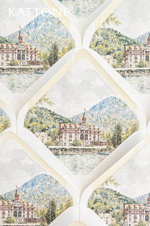 Close-up of luxury ivory wedding envelopes with custom watercolor liners featuring an elegant European lakeside hotel, a tranquil blue lake, lush green trees, and towering Alpine mountains. The soft blue, sage green, and warm terracotta watercolor illustration is framed by cream-colored envelope interiors, creating romantic destination wedding stationery.