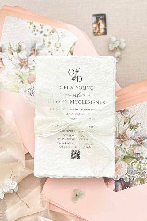 Complete luxury wedding invitation suite including handmade invitation, lace wrap, blush envelopes and botanical watercolor envelope liners.