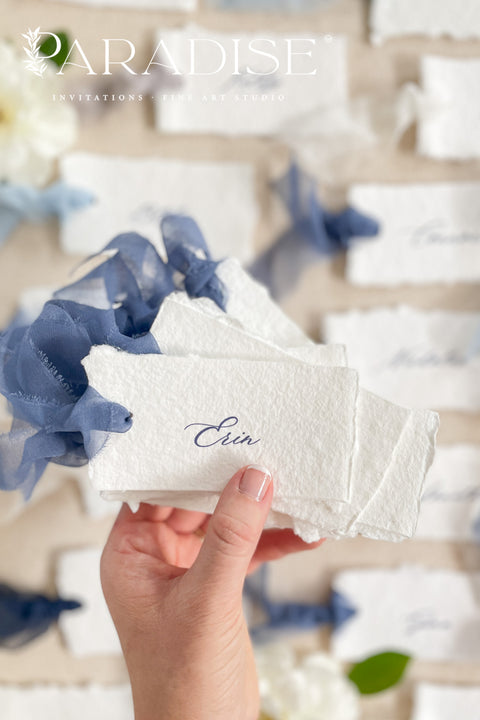 Add soft, romantic detailing to your tablescape with our silk ribbon handmade paper place cards, crafted from premium cotton rag paper and finished with naturally torn deckled edges. Each name tag is threaded with airy, hand-dyed silk ribbon and printed in elegant calligraphy, creating a luxurious fine-art look for weddings, rehearsal dinners, and intimate celebrations. These artisan-crafted cards bring movement, texture, and timeless beauty to your event design.