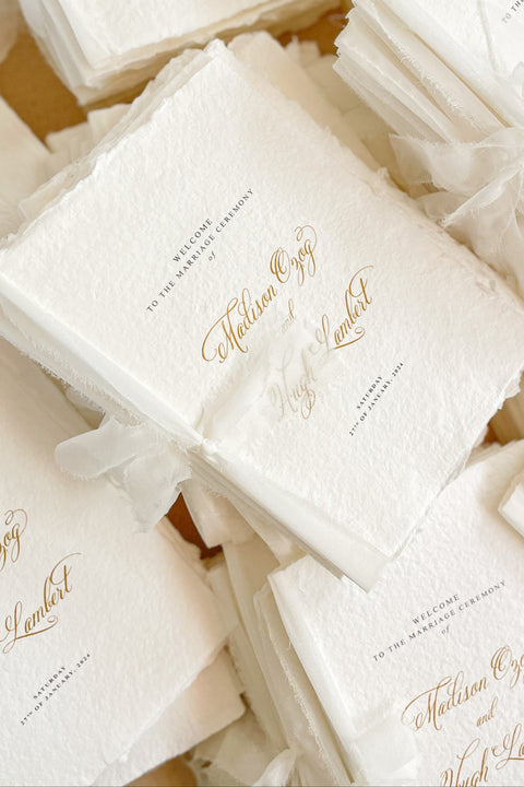 A beautifully handcrafted wedding program made from premium cotton paper, designed to elevate your ceremony with soft texture, timeless script, and a romantic ribbon finish. Each program is thoughtfully created to introduce your guests to the most meaningful moments of your day, blending fine-art aesthetics with the warmth of handmade craftsmanship. Ideal for classic, garden, or luxury weddings, it delivers a refined first impression that sets the tone for a heartfelt celebration.