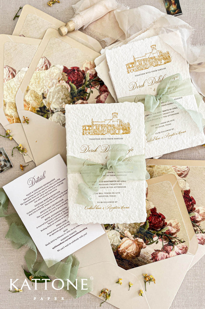 Luxury handmade cotton paper wedding invitation with deckled edges and gold venue illustration, styled with sage silk ribbon, floral envelope liners and coordinated stationery suite.