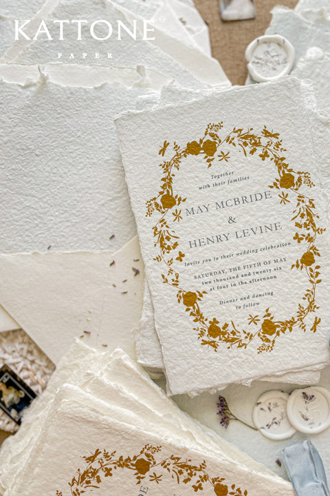 Invite your guests to your special day with the artful beauty of these exquisite handmade paper wedding invites. Perfect for a garden wedding, these invitations feature a delicate golden leaf addition, providing a touch of understated elegance and luxurious shimmer. The tactile and organic feel of the deckle edge paper creates a truly memorable keepsake, setting a romantic and refined tone for your celebration.