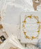 Invite your guests to your special day with the artful beauty of these exquisite handmade paper wedding invites. Perfect for a garden wedding, these invitations feature a delicate golden leaf addition, providing a touch of understated elegance and luxurious shimmer. The tactile and organic feel of the deckle edge paper creates a truly memorable keepsake, setting a romantic and refined tone for your celebration.