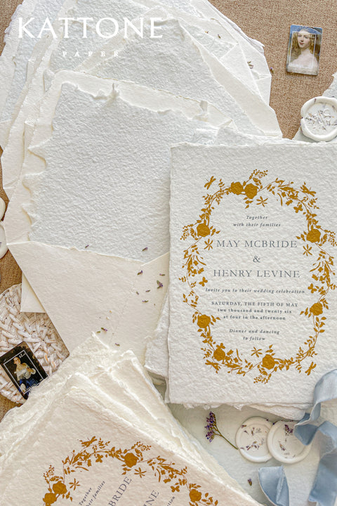 Invite your guests to your special day with the artful beauty of these exquisite handmade paper wedding invites. Perfect for a garden wedding, these invitations feature a delicate golden leaf addition, providing a touch of understated elegance and luxurious shimmer. The tactile and organic feel of the deckle edge paper creates a truly memorable keepsake, setting a romantic and refined tone for your celebration.