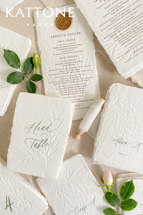 Discover refined craftsmanship with our embossed handmade wedding menus, designed to elevate your reception with timeless luxury. Each piece is pressed onto cotton handmade paper featuring delicate botanical embossing and finished with a wax seal for a touch of old-world elegance. Perfect for fine-art, romantic, or luxury weddings, these menus combine artisanal texture with understated sophistication.
