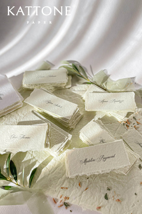 Bring artisanal beauty to your event with our handmade paper place cards, crafted from luxurious cotton rag paper and detailed with natural deckled edges. Each card features a pressed dried floral element sealed beneath a creamy wax stamp, creating a textured fine-art look perfect for garden weddings, outdoor celebrations, and romantic gatherings. These one-of-a-kind place cards add organic charm, timeless artistry, and meaningful detail to every tablescape.