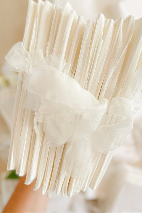 A beautifully handcrafted wedding program made from premium cotton paper, designed to elevate your ceremony with soft texture, timeless script, and a romantic ribbon finish. Each program is thoughtfully created to introduce your guests to the most meaningful moments of your day, blending fine-art aesthetics with the warmth of handmade craftsmanship. Ideal for classic, garden, or luxury weddings, it delivers a refined first impression that sets the tone for a heartfelt celebration.