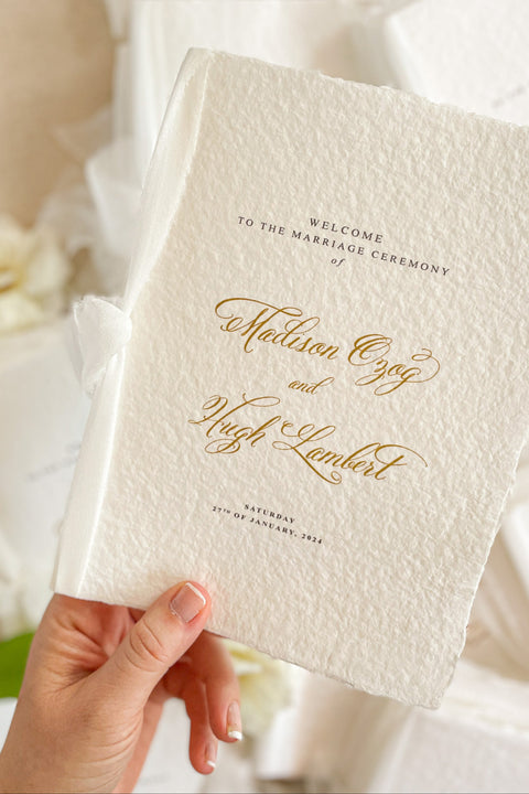 A beautifully handcrafted wedding program made from premium cotton paper, designed to elevate your ceremony with soft texture, timeless script, and a romantic ribbon finish. Each program is thoughtfully created to introduce your guests to the most meaningful moments of your day, blending fine-art aesthetics with the warmth of handmade craftsmanship. Ideal for classic, garden, or luxury weddings, it delivers a refined first impression that sets the tone for a heartfelt celebration.