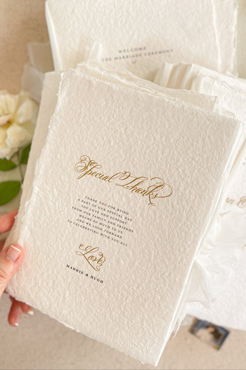 A beautifully handcrafted wedding program made from premium cotton paper, designed to elevate your ceremony with soft texture, timeless script, and a romantic ribbon finish. Each program is thoughtfully created to introduce your guests to the most meaningful moments of your day, blending fine-art aesthetics with the warmth of handmade craftsmanship. Ideal for classic, garden, or luxury weddings, it delivers a refined first impression that sets the tone for a heartfelt celebration.