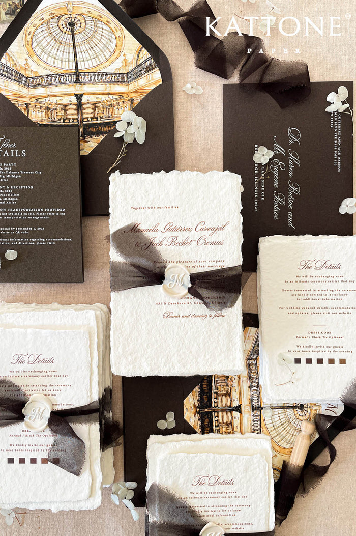 Luxury handmade paper wedding invitation suite featuring deckled edge cotton paper, custom architectural venue artwork, chocolate brown envelopes with illustrated liners, black chiffon ribbon wraps, and personalized wax seals.