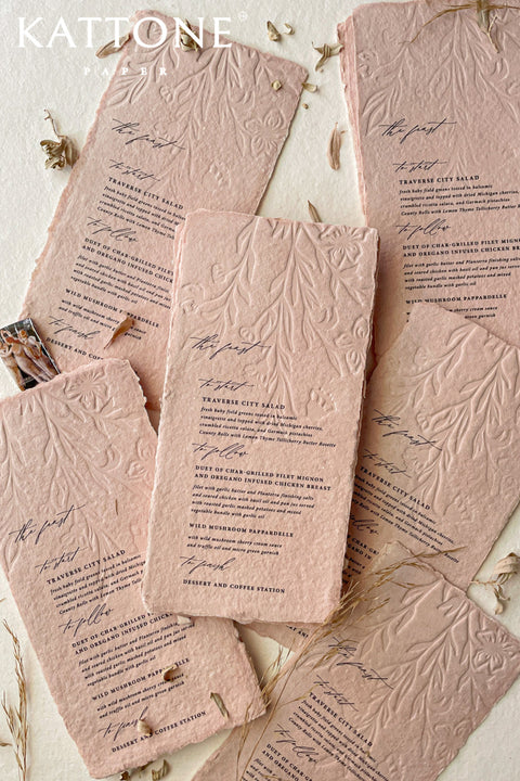 These embossed handmade wedding menus are a striking fusion of texture, color, and craftsmanship - designed to make a refined statement at your celebration. Crafted from luxurious cotton rag paper and tinted in a soft, romantic blush hue, each menu features an intricate embossed botanical design that adds depth and dimension. 