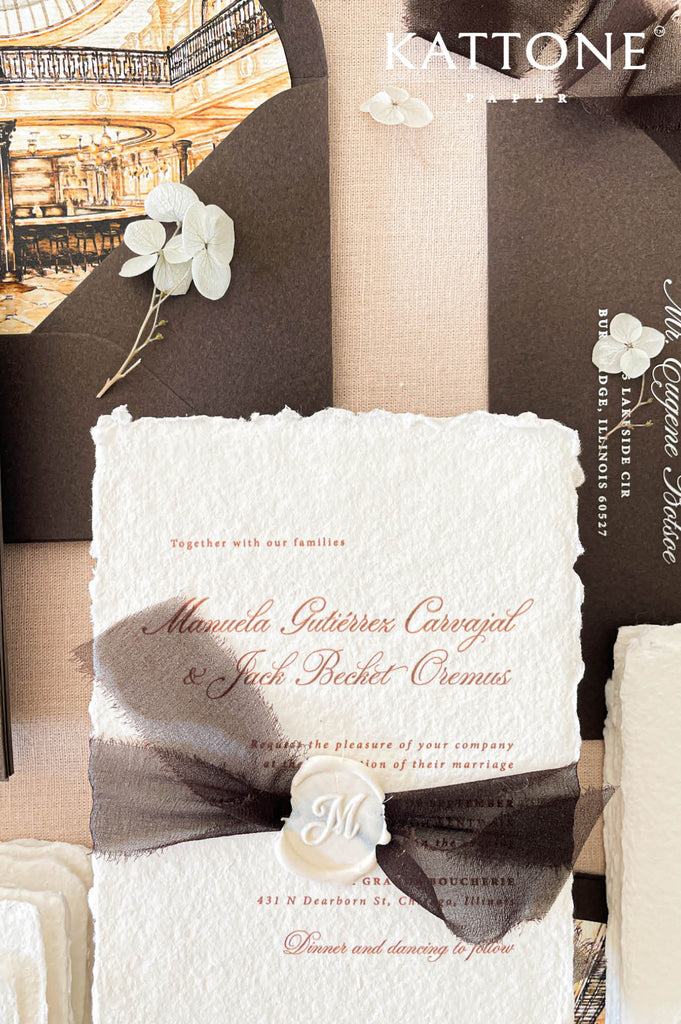 Elegant handmade cotton paper wedding invitation with deckled edges featuring refined script typography, black chiffon ribbon wrap, and personalized ivory wax seal.