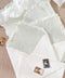 Handmade paper envelopes with envelope liners styled on textured fabric with silk ribbon and fine art wedding stationery details.