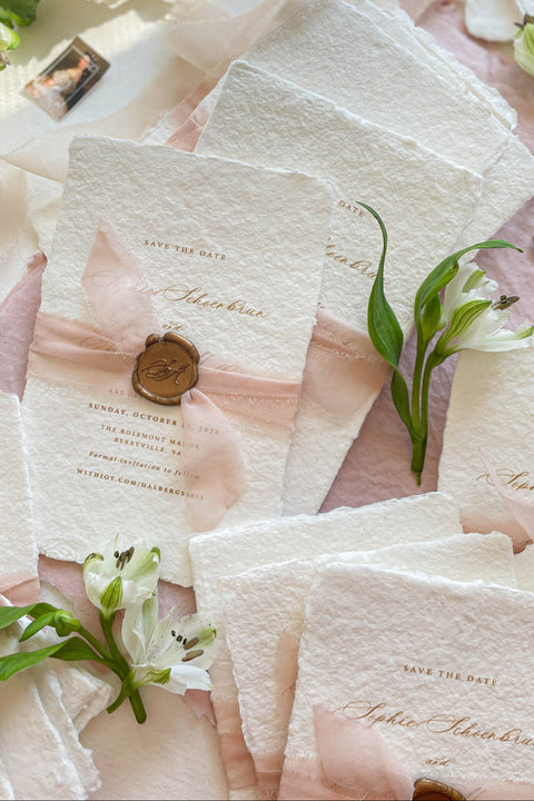 Announce your wedding day with effortless elegance through our handmade paper Save the Date cards, a perfect blend of romance and artisanal craftsmanship. Printed on luxury 100% cotton paper with soft deckled edges, each piece is wrapped in a delicate blush silk ribbon and finished with a hand-pressed wax seal, creating a timeless keepsake that captures the essence of fine-art stationery.