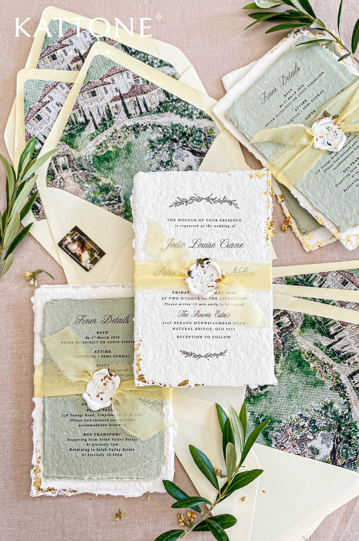Handmade cotton paper wedding invitation with deckled edges, gold leaf edging and elegant typography, styled with yellow chiffon ribbon and illustrated venue envelope liners.