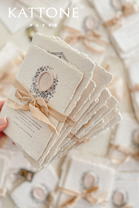 Invite your guests to your special day with the artful and personal charm of these custom wedding invitations. The unique suite features a beautiful, custom venue illustration sketch, hand-drawn by us to capture the essence of your wedding location. Designed with a light summer breeze theme and a boho chic aesthetic, this wedding stationery sets a warm, relaxed, and intimate tone for your upcoming celebration.