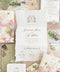 Luxury tri-fold handmade paper wedding invitation suite featuring concertina-style deckled edge cotton paper, custom floral artwork, vellum wraps, blush chiffon ribbon ties, and coordinating stationery pieces.