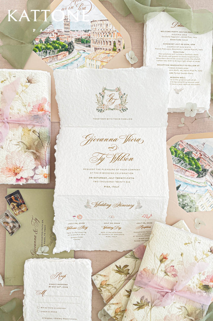 Luxury tri-fold handmade paper wedding invitation suite featuring concertina-style deckled edge cotton paper, custom floral artwork, vellum wraps, blush chiffon ribbon ties, and coordinating stationery pieces.