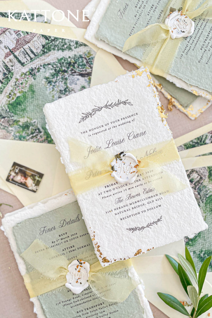 Complete luxury wedding invitation suite including handmade invitation, gold edging, ribbon wrap and illustrated envelope liners.