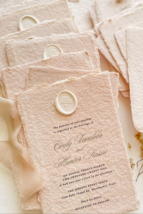 Elevate your wedding with our exquisite Handmade Paper Wedding Invitations featuring beautiful deckled edges. Crafted with love and attention to detail, these elegant invitations are tied together with luxurious silk ribbon, adding a touch of sophistication to your special day. Each piece is uniquely handmade, ensuring your announcements are as one-of-a-kind as your love story. 