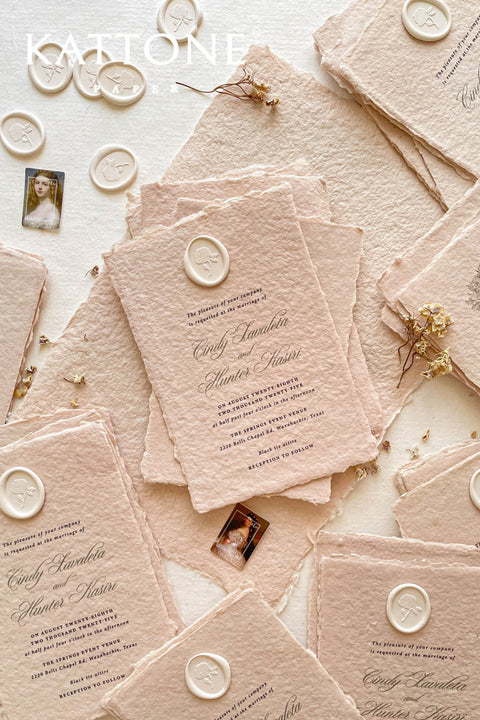 Elevate your wedding with our exquisite Handmade Paper Wedding Invitations featuring beautiful deckled edges. Crafted with love and attention to detail, these elegant invitations are tied together with luxurious silk ribbon, adding a touch of sophistication to your special day. Each piece is uniquely handmade, ensuring your announcements are as one-of-a-kind as your love story. 