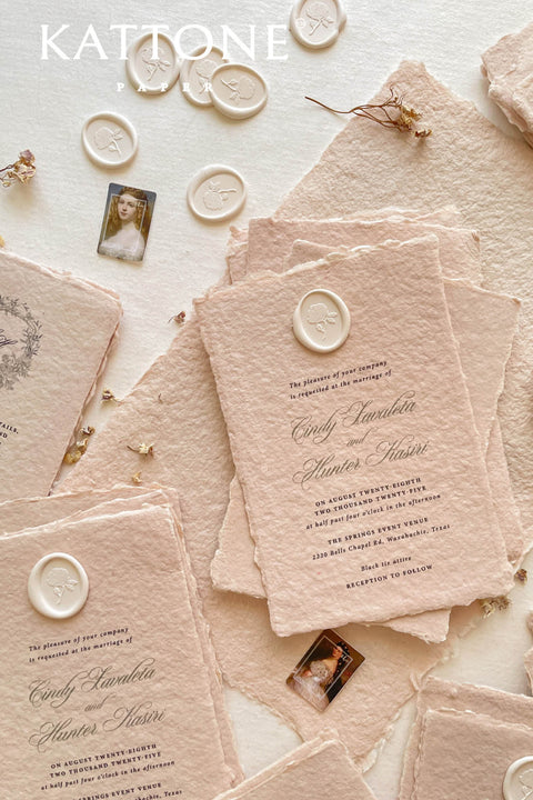 Elevate your wedding with our exquisite Handmade Paper Wedding Invitations featuring beautiful deckled edges. Crafted with love and attention to detail, these elegant invitations are tied together with luxurious silk ribbon, adding a touch of sophistication to your special day. Each piece is uniquely handmade, ensuring your announcements are as one-of-a-kind as your love story. 