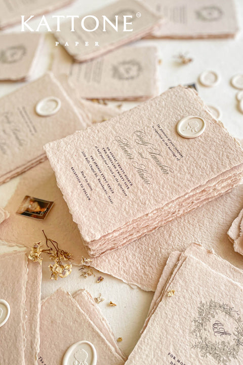 Elevate your wedding with our exquisite Handmade Paper Wedding Invitations featuring beautiful deckled edges. Crafted with love and attention to detail, these elegant invitations are tied together with luxurious silk ribbon, adding a touch of sophistication to your special day. Each piece is uniquely handmade, ensuring your announcements are as one-of-a-kind as your love story. 