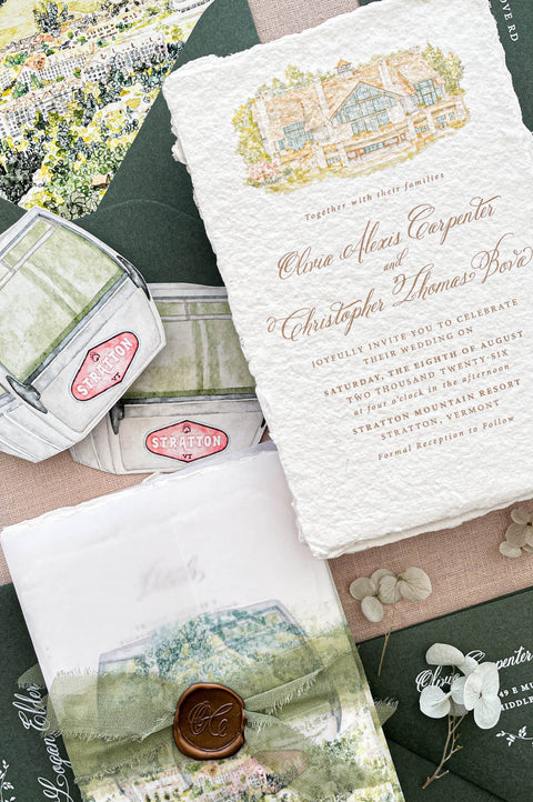 Premium handmade paper wedding invitation suite with custom watercolor venue illustration, scenic vellum wraps, deckled edge cotton paper, sage green envelopes, wax seal accents, and fine art stationery details for elegant destination weddings.