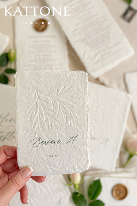 Discover refined craftsmanship with our embossed handmade wedding menus, designed to elevate your reception with timeless luxury. Each piece is pressed onto cotton handmade paper featuring delicate botanical embossing and finished with a wax seal for a touch of old-world elegance. Perfect for fine-art, romantic, or luxury weddings, these menus combine artisanal texture with understated sophistication.