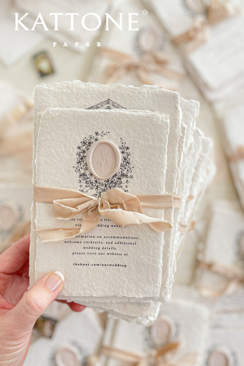 Invite your guests to your special day with the artful and personal charm of these custom wedding invitations. The unique suite features a beautiful, custom venue illustration sketch, hand-drawn by us to capture the essence of your wedding location. Designed with a light summer breeze theme and a boho chic aesthetic, this wedding stationery sets a warm, relaxed, and intimate tone for your upcoming celebration.