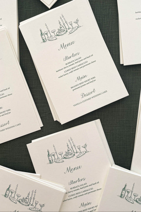 Stack of wedding menus showcasing uniform printing, clean edges and cohesive design.