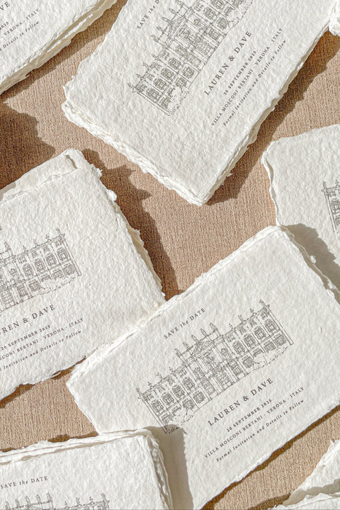Celebrate your wedding story with timeless sophistication through our handmade paper Save the Date cards, featuring a hand-drawn illustration of your wedding venue printed on luxury cotton handmade paper. The natural deckled edges and fine-line artwork bring a touch of romantic authenticity, while the contrasting black envelopes add a modern, refined edge.