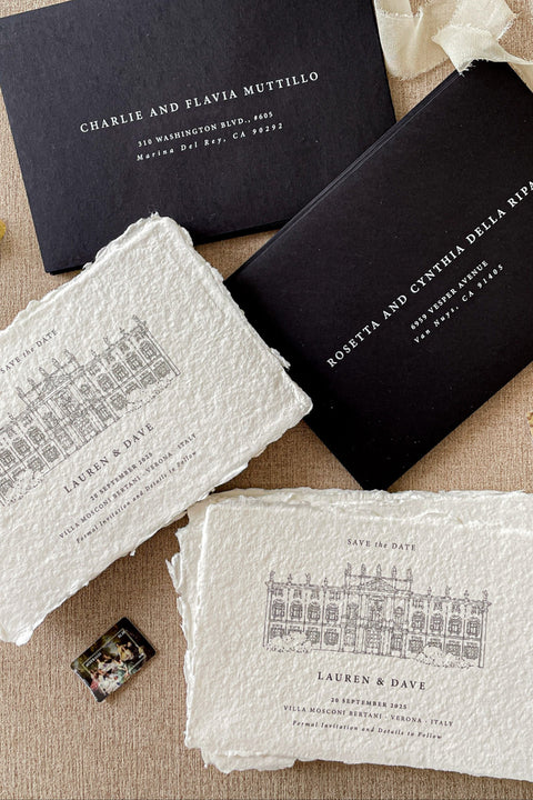 Celebrate your wedding story with timeless sophistication through our handmade paper Save the Date cards, featuring a hand-drawn illustration of your wedding venue printed on luxury cotton handmade paper. The natural deckled edges and fine-line artwork bring a touch of romantic authenticity, while the contrasting black envelopes add a modern, refined edge.