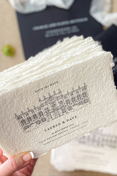 Celebrate your wedding story with timeless sophistication through our handmade paper Save the Date cards, featuring a hand-drawn illustration of your wedding venue printed on luxury cotton handmade paper. The natural deckled edges and fine-line artwork bring a touch of romantic authenticity, while the contrasting black envelopes add a modern, refined edge.
