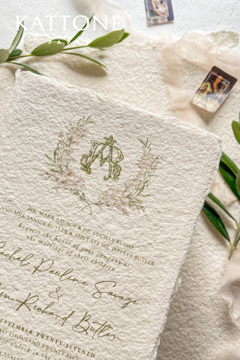 Soft, organic, and undeniably romantic - this colored handmade paper wedding invitation suite beautifully captures the essence of nature-inspired elegance. Printed on luxury blush-toned deckled-edge cotton paper, each piece is a work of art, blending timeless craftsmanship with delicate botanical elements and refined greenery details. At its heart lies a custom hand-drawn monogram, surrounded by soft watercolor foliage - a symbol of the couple’s unity and natural grace. 