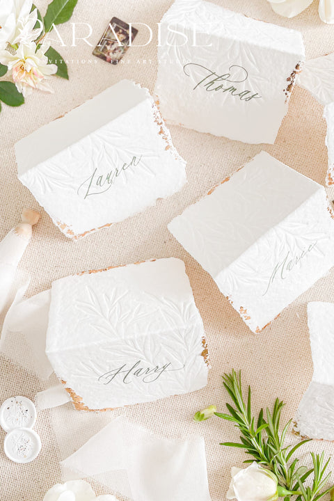 Elevate your table setting with our embossed handmade paper place cards - a luxurious detail for weddings, bridal showers, and upscale events. Each card is crafted from premium cotton rag paper, featuring a soft deckled edge, botanical embossing, and elegant calligraphy. Perfect for seating arrangements, escort cards, or personalized name tags, these artisanal pieces bring a touch of organic elegance to any celebration. 