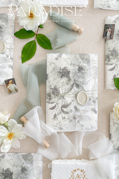 Our handmade wedding invitation suite features a custom hand-drawn monogram, printed on luxury deckled-edge cotton paper, and wrapped in translucent vellum jackets adorned with fine art floral illustrations. Each suite is finished with a silk ribbon and wax seal, blending old-world romance with modern artistry. Designed for couples who cherish attention to detail, this suite embodies elegance and craftsmanship - perfect for fine art, garden, or destination weddings.