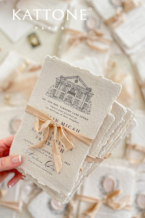 Invite your guests to your special day with the artful and personal charm of these custom wedding invitations. The unique suite features a beautiful, custom venue illustration sketch, hand-drawn by us to capture the essence of your wedding location. Designed with a light summer breeze theme and a boho chic aesthetic, this wedding stationery sets a warm, relaxed, and intimate tone for your upcoming celebration.