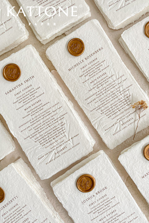Discover refined craftsmanship with our embossed handmade wedding menus, designed to elevate your reception with timeless luxury. Each piece is pressed onto cotton handmade paper featuring delicate botanical embossing and finished with a wax seal for a touch of old-world elegance. Perfect for fine-art, romantic, or luxury weddings, these menus combine artisanal texture with understated sophistication.