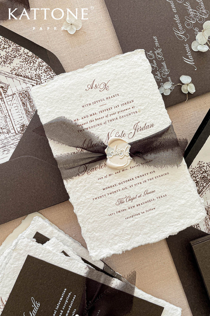 Handmade cotton paper wedding invitations with deckled edges paired with deep brown envelopes and coordinating details cards.